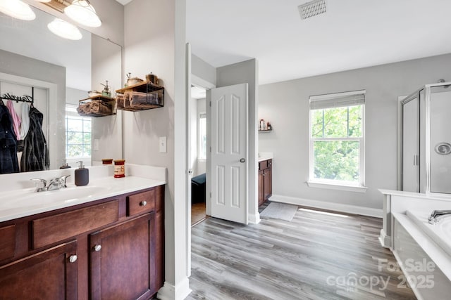 14940 Carbert Ln, Huntersville, NC 28078 - bathroom featuring vanity, plenty of natural light, a bath, and wood finished floors