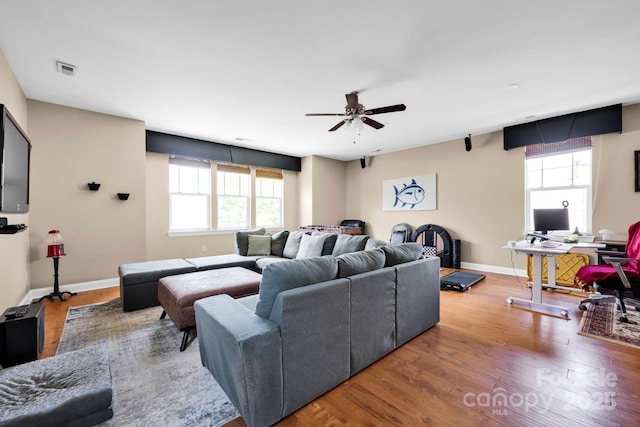 14940 Carbert Ln, Huntersville, NC 28078 - living area with healthy amount of natural light, wood finished floors, a ceiling fan, and baseboards