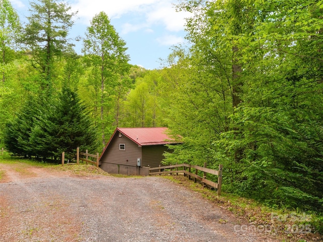 416 Secluded Cv, Waynesville, NC 28785 - view of home's exterior featuring a forest view, metal roof, and fence