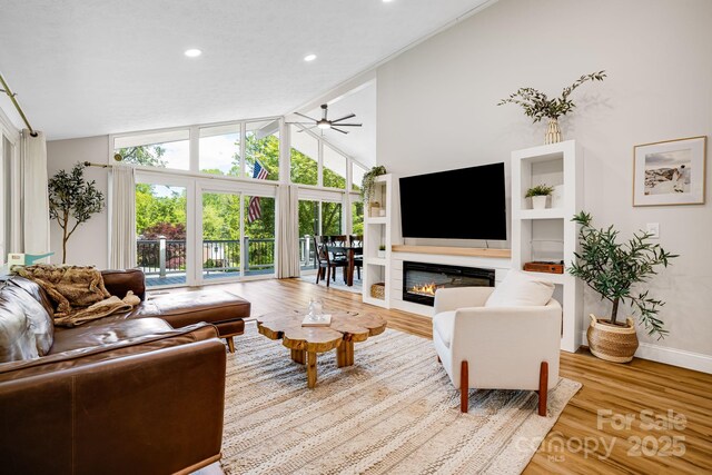 2044 Glenheath Dr, Hendersonville, NC 28791 - living room featuring lofted ceiling, baseboards, healthy amount of natural light, wood finished floors, and recessed lighting
