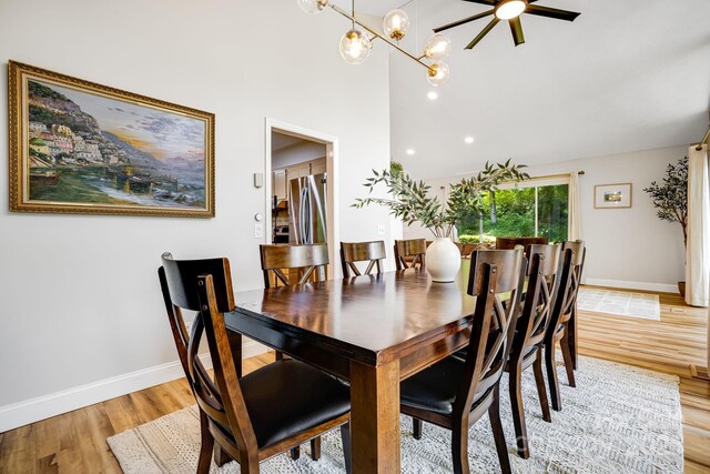 2044 Glenheath Dr, Hendersonville, NC 28791 - dining area with light wood-style flooring, vaulted ceiling, baseboards, and a chandelier