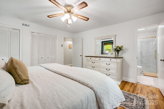 2044 Glenheath Dr, Hendersonville, NC 28791 - bedroom featuring multiple closets, light wood-style floors, baseboards, ensuite bathroom, and ceiling fan