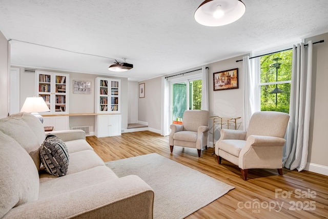 2044 Glenheath Dr, Hendersonville, NC 28791 - living area with wood finished floors, a textured ceiling, baseboards, and built in shelves