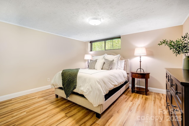 2044 Glenheath Dr, Hendersonville, NC 28791 - bedroom featuring baseboards, light wood-style flooring, and a textured ceiling