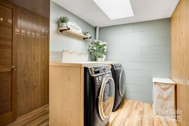 2044 Glenheath Dr, Hendersonville, NC 28791 - washroom with light wood-style floors, washer and dryer, and concrete block wall