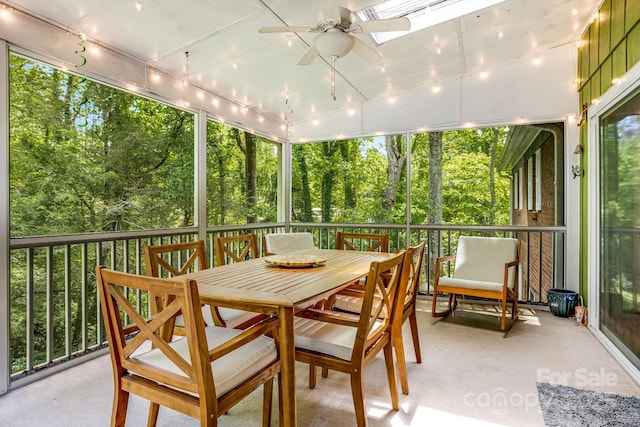 2044 Glenheath Dr, Hendersonville, NC 28791 - sunroom / solarium with ceiling fan, a skylight, outdoor dining area, and view of scattered trees