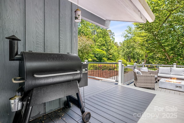 2044 Glenheath Dr, Hendersonville, NC 28791 - deck featuring an outdoor living space with a fire pit, area for grilling, and view of wooded area