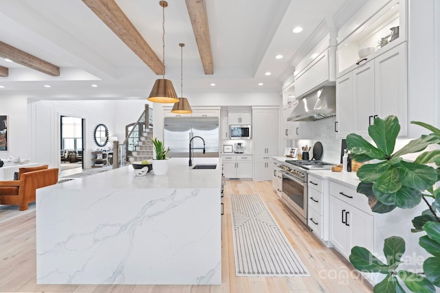 17416 Gillican Overlook Rd, Davidson, NC 28036 - kitchen with built in appliances, beamed ceiling, wall chimney range hood, backsplash, and light wood-type flooring