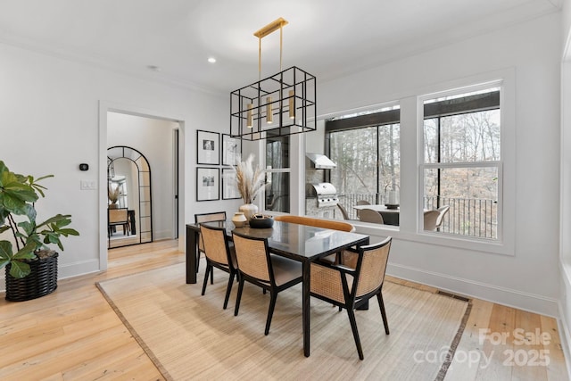 17416 Gillican Overlook Rd, Davidson, NC 28036 - dining space featuring wood finished floors, ornamental molding, baseboards, and a chandelier