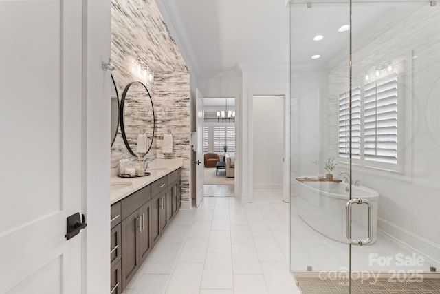 17416 Gillican Overlook Rd, Davidson, NC 28036 - ensuite bathroom featuring ornamental molding, double vanity, baseboards, a soaking tub, and plenty of natural light