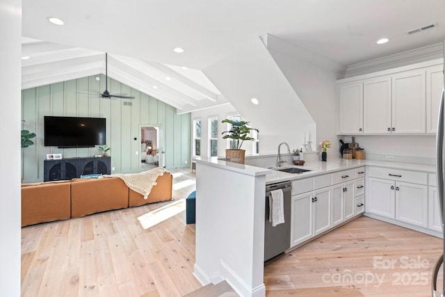 17416 Gillican Overlook Rd, Davidson, NC 28036 - kitchen with a sink, stainless steel dishwasher, open floor plan, light wood finished floors, and white cabinetry