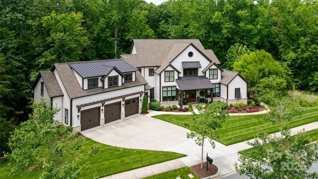 17416 Gillican Overlook Rd, Davidson, NC 28036 - view of front of home with a standing seam roof, concrete driveway, a front yard, and metal roof