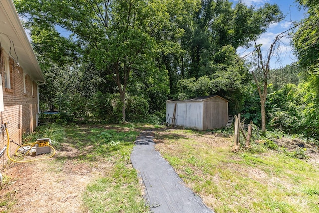 view of yard with a storage shed and an outbuilding