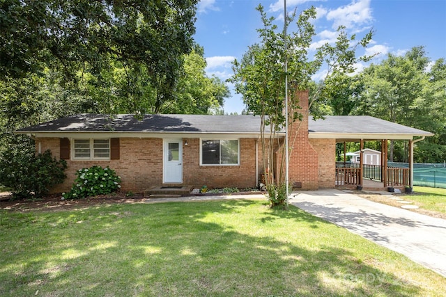 view of front of home with an attached carport, a shed, a chimney, and brick siding