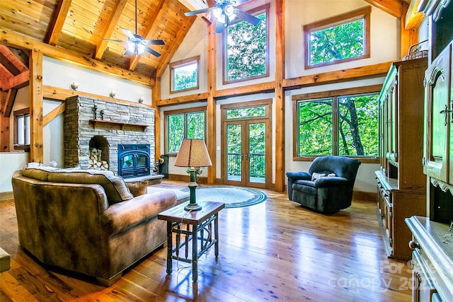 58 Great Aspen Way, Black Mountain, NC 28711 - living room with high vaulted ceiling, hardwood / wood-style floors, ceiling fan, wood ceiling with exposed beams, and a stone fireplace