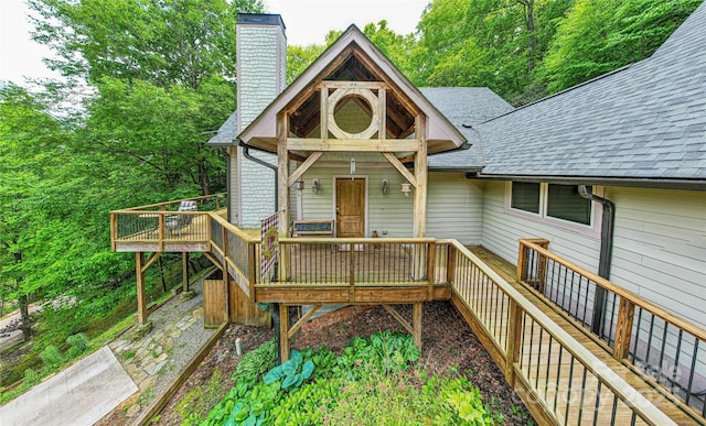 58 Great Aspen Way, Black Mountain, NC 28711 - view of front facade with a shingled roof, a chimney, and a wooden deck