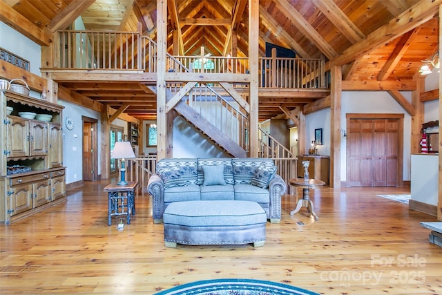 58 Great Aspen Way, Black Mountain, NC 28711 - living room with high vaulted ceiling, hardwood / wood-style flooring, baseboards, wood ceiling with exposed beams, and stairs