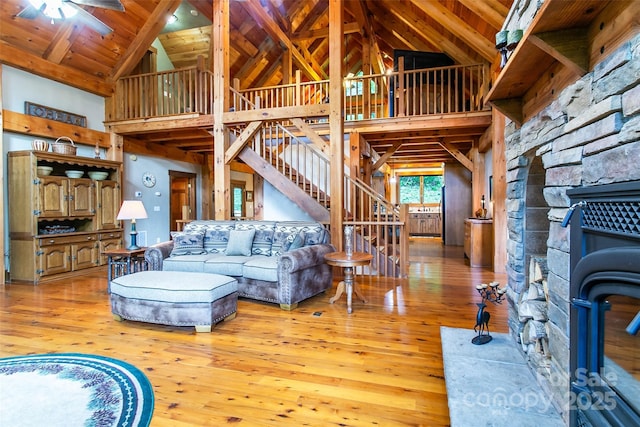 58 Great Aspen Way, Black Mountain, NC 28711 - living area featuring high vaulted ceiling, a wood stove, light wood-style flooring, stairs, and a ceiling fan