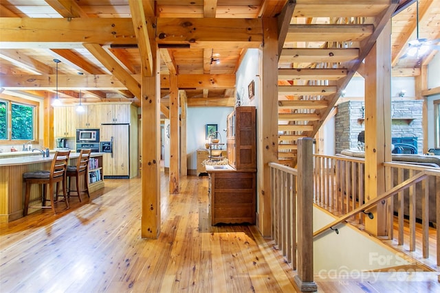 58 Great Aspen Way, Black Mountain, NC 28711 - hall featuring light wood-type flooring, wooden ceiling with exposed beams, and an upstairs landing