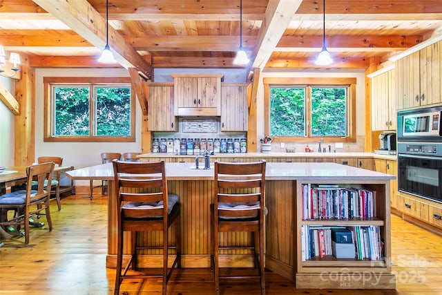 58 Great Aspen Way, Black Mountain, NC 28711 - kitchen with black oven, light countertops, wooden ceiling with exposed beams, plenty of natural light, and light wood-style floors