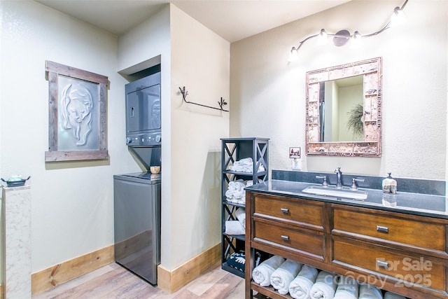 58 Great Aspen Way, Black Mountain, NC 28711 - bathroom featuring stacked washer / dryer, vanity, wood finished floors, and baseboards