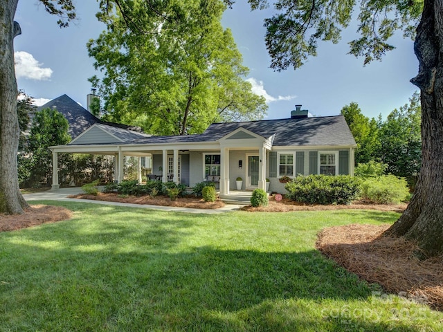 1069 Sedgefield Rd, Charlotte, NC 28209 - view of front of home with covered porch, a front yard, and a chimney