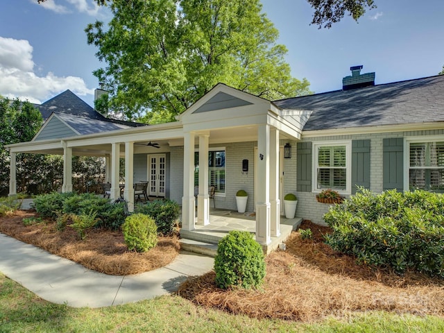 1069 Sedgefield Rd, Charlotte, NC 28209 - view of front of home with french doors, a chimney, brick siding, roof with shingles, and covered porch
