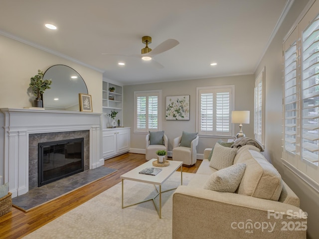 1069 Sedgefield Rd, Charlotte, NC 28209 - living room with wood finished floors, ceiling fan, crown molding, a tile fireplace, and recessed lighting