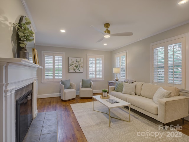 1069 Sedgefield Rd, Charlotte, NC 28209 - living area featuring crown molding, a ceiling fan, wood finished floors, a tiled fireplace, and baseboards