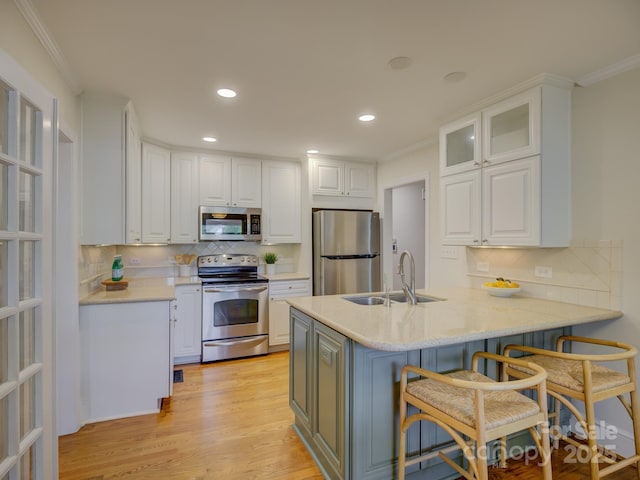 1069 Sedgefield Rd, Charlotte, NC 28209 - kitchen featuring stainless steel appliances, a peninsula, a sink, backsplash, and ornamental molding