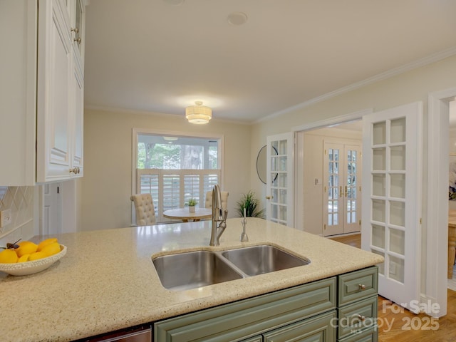 1069 Sedgefield Rd, Charlotte, NC 28209 - kitchen featuring a sink, french doors, crown molding, green cabinets, and white cabinets