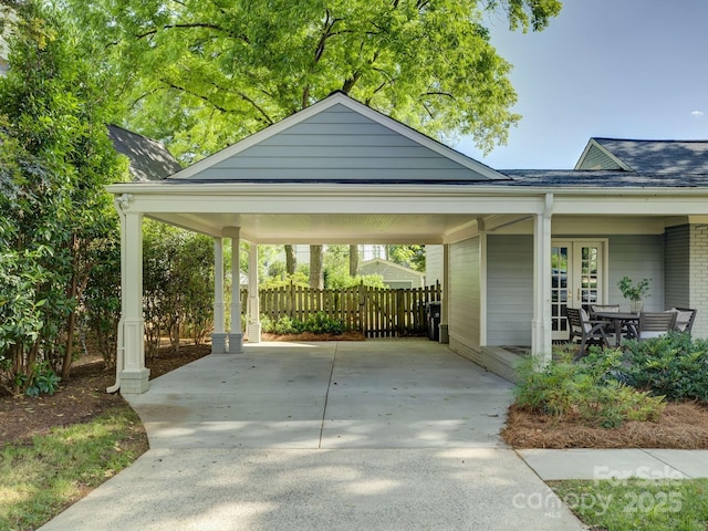 1069 Sedgefield Rd, Charlotte, NC 28209 - view of parking with concrete driveway, a carport, and french doors