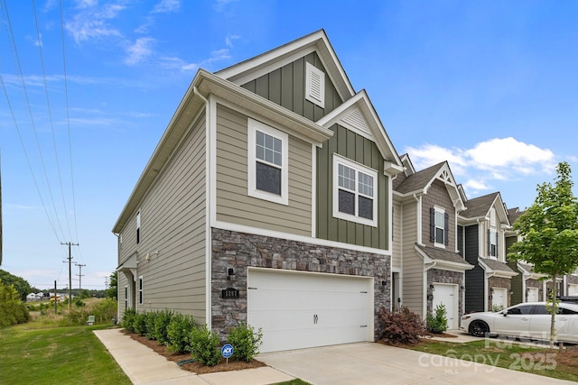 5207 Maynard Hill Dr, Monroe, NC 28110 - view of front of house with board and batten siding, an attached garage, concrete driveway, and stone siding