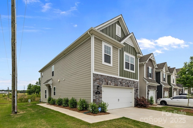 5207 Maynard Hill Dr, Monroe, NC 28110 - view of side of property with board and batten siding, driveway, a garage, a yard, and stone siding