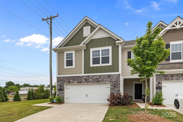 5207 Maynard Hill Dr, Monroe, NC 28110 - view of front of house with board and batten siding, stone siding, an attached garage, and driveway