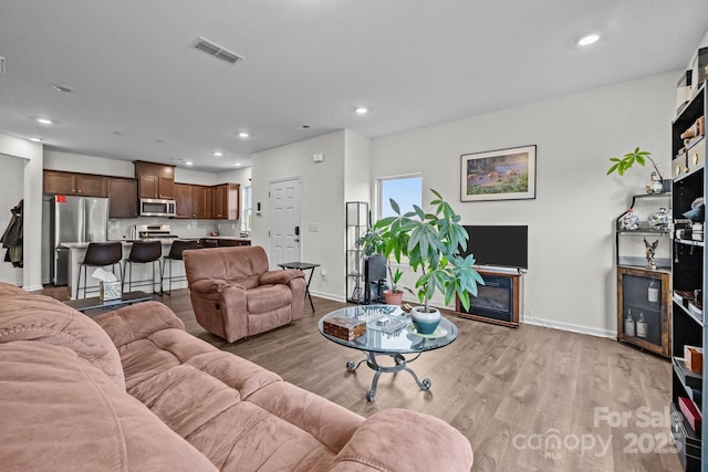 5207 Maynard Hill Dr, Monroe, NC 28110 - living room with baseboards, light wood finished floors, and recessed lighting