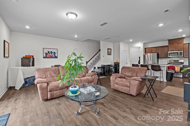5207 Maynard Hill Dr, Monroe, NC 28110 - living area featuring wood finished floors, recessed lighting, stairs, and baseboards