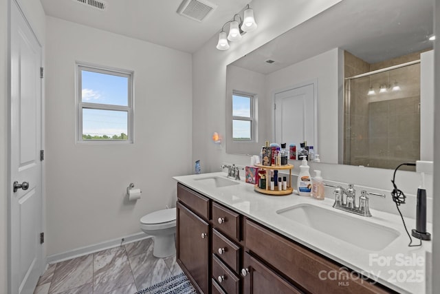 5207 Maynard Hill Dr, Monroe, NC 28110 - full bath with baseboards, double vanity, toilet, tiled shower, and marble finish flooring