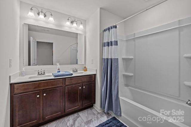 5207 Maynard Hill Dr, Monroe, NC 28110 - full bathroom with marble look tile flooring, shower / tub combo with curtain, double vanity, and baseboards