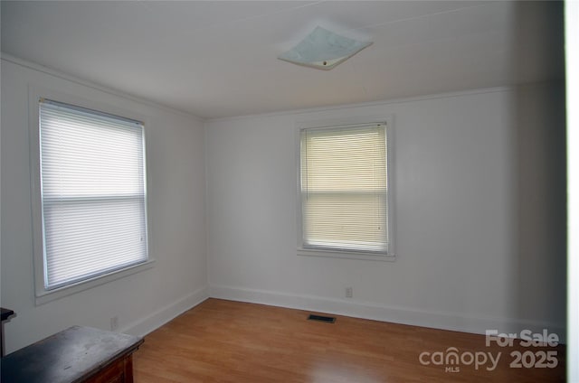 60 3rd St, Marion, NC 28752 - empty room featuring baseboards, light wood-style floors, and crown molding