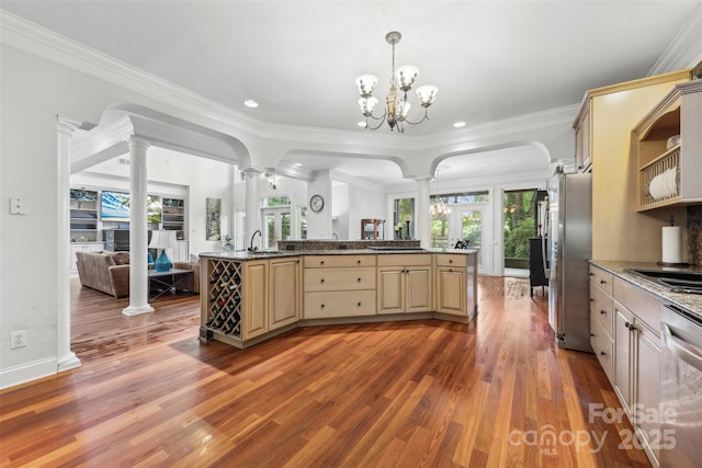 3932 Rounding Run Rd, Charlotte, NC 28277 - kitchen with ornate columns, a sink, stainless steel appliances, open floor plan, and light wood-type flooring