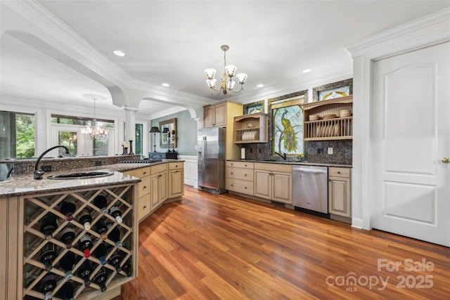 3932 Rounding Run Rd, Charlotte, NC 28277 - bar with stainless steel appliances, a chandelier, decorative columns, light wood finished floors, and a sink