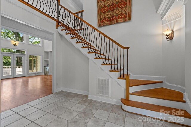 3932 Rounding Run Rd, Charlotte, NC 28277 - staircase with a high ceiling, tile patterned flooring, and french doors