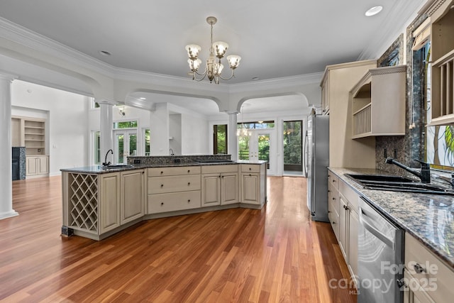 3932 Rounding Run Rd, Charlotte, NC 28277 - kitchen with decorative columns, appliances with stainless steel finishes, cream cabinets, healthy amount of natural light, and crown molding
