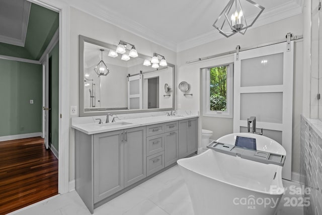 3932 Rounding Run Rd, Charlotte, NC 28277 - bathroom with double vanity, a freestanding tub, crown molding, and a chandelier