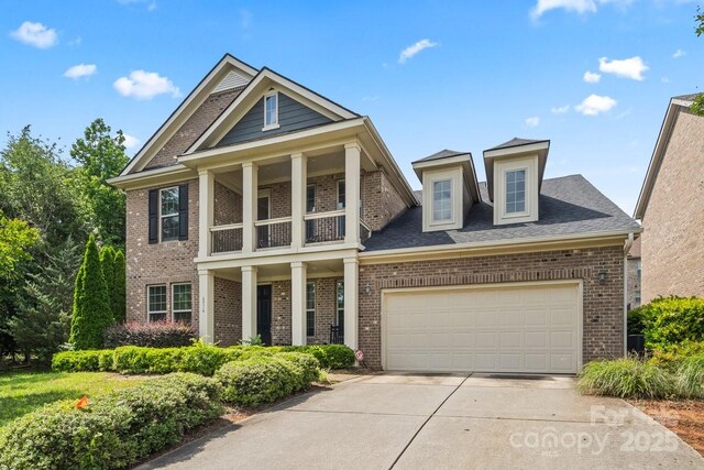 8514 Ellington Park Dr, Charlotte, NC 28277 - view of front of house with brick siding, a balcony, concrete driveway, and a garage