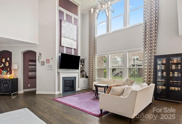 8514 Ellington Park Dr, Charlotte, NC 28277 - living room with a towering ceiling, a fireplace with flush hearth, wood-type flooring, healthy amount of natural light, and baseboards