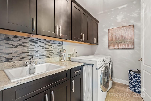 8514 Ellington Park Dr, Charlotte, NC 28277 - laundry room featuring cabinet space, washer and dryer, baseboards, and light wood-style floors