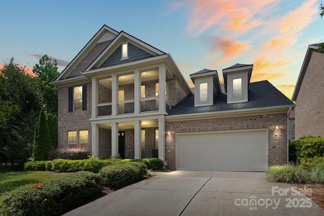 8514 Ellington Park Dr, Charlotte, NC 28277 - neoclassical / greek revival house with brick siding, driveway, an attached garage, and a balcony