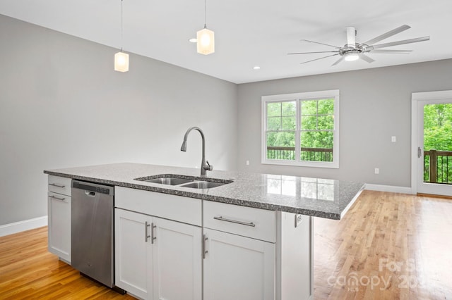 200 N Skyloft Dr Unit 2, Asheville, NC 28801 - kitchen featuring stainless steel dishwasher, a sink, light wood-type flooring, an island with sink, and white cabinetry